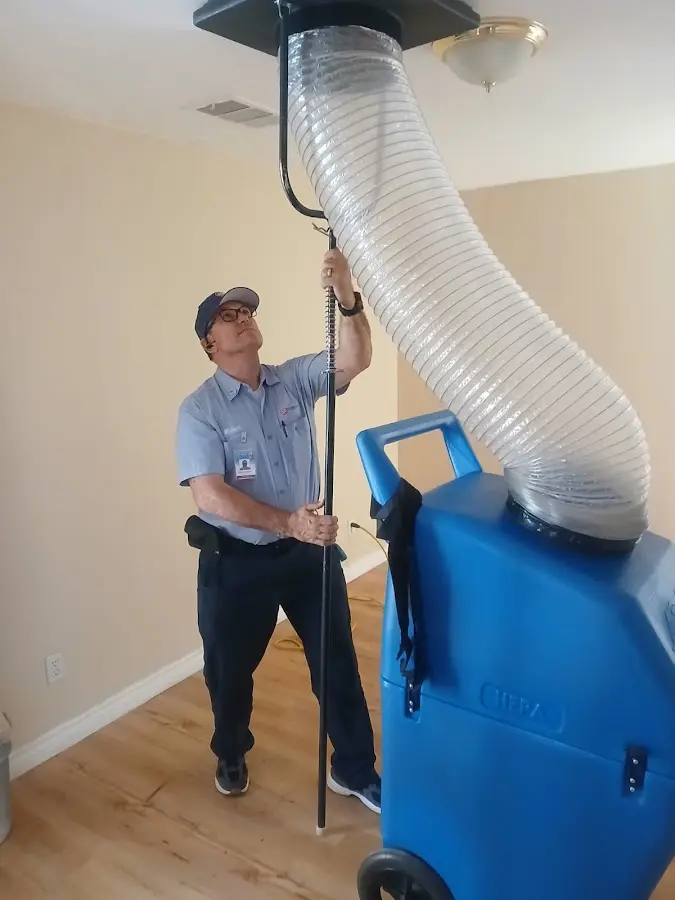 Furnace Tune-Up technician using HEPA equipment in Landen